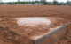 A home plate on a baseball diamond, nearly completely covered by dirt. (Photo by Andrew Dallos via Flickr/Creative Commons https://flic.kr/p/7UQByt)