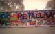 Someone spray painted "METALLICA" in big black letters on a wall of colorful graffiti. (Photo by Alaska Carter via Flickr/Creative Commons https://flic.kr/p/aGji8P)