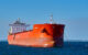 A red cargo ship at sea. (Photo by Pedro Szekely via Flickr/Creative Commons https://flic.kr/p/TYgSTL)