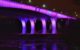 35W bridge in Minneapolis illuminated purple. (Photo by jpellgen via Flickr/Creative Commons https://flic.kr/p/G6fwsf)