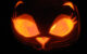 A lit Jack O'Lantern carved to look like a cat. (Photo by Aimee Ray via Flickr/Creative Commons https://flic.kr/p/5ygwLN)