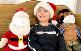 Five year old with Santa and Mr. T (who are wearing masks)