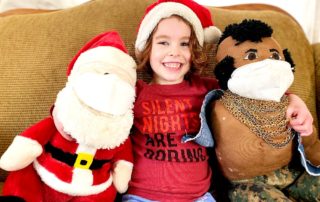 Four year old with Santa and Mr. T (who are wearing masks)