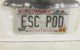 License plate reads "ESC POD"