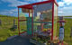 A bus shelter with flowers, art on display and colorful curtains. (Photo by Peter Stenzel via Flickr/Creative Commons https://flic.kr/p/ZnfgQm)