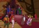 In Castle Greyskull's throne room, Zagraz the magician levitates three yellow balls over Prince Adam's head, while the other good guy characters watch