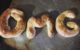 Three homemade baked pretzels spell out OMG