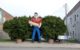 Giant fiberglass statue of a man in a red shirt and blue jeans holding a giant hot dog. (Photo by JymPoiranges via Flickr/Creative Commons https://flic.kr/p/rtLDKX)