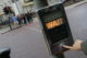 A hand pushes a button on a crosswalk sign, lit up to say "WAIT" (Photo by mat_n via Flickr/Creative Commons https://flic.kr/p/2pf9kY)