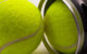 Two tennis balls covered in yellow fluorescent nap and having white curved rubber band. One of the balls is still inside a black plastic container with a shiny metal circular ending. (Photo by Old Photo Profile via Flickr/Creative Commons https://flic.kr/p/7vBa2x)