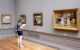 A woman looks at paintings in an art museum. (Photo by Stanley Zimmy via Flickr/Creative Commons https://flic.kr/p/qAtUW8)