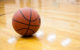 A basketball on a wooden court. (Photo by Franchise Opportunities via Flickr/Creative Commons https://flic.kr/p/UfuMwf)