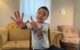 Six year old holds up the number six with his fingers!