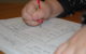 Closeup of a kid's hands as they do a worksheet. (Photo by Catherine via Flickr/Creative Commons https://flic.kr/p/5R39Qp)