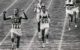 Billy Mills crosses the finish line at the 1964 Olympics. Official Marine Corps Photo # A411758 - History Division, United States Marine Corps (main page on 2008-08-14), Public Domain, https://commons.wikimedia.org/w/index.php?curid=4561267