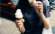 A person tasting an ice cream cone while holding a second cone. (Photo by r a c h e l via Flickr/Creative Commons https://flic.kr/p/kMp9U)