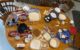 The dining room table is covered in bowls of flour, sugar, fruit, chocolate, butter and other ingredients.