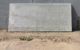 A rectangular concrete slab leaning against a concrete wall. (Photo via Joost Markerink via Flickr/Creative Commons https://flic.kr/p/252wpNx)