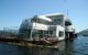 Friendship 500, a floating McDonald's restaurant, also known as the McBarge, anchored in Burrard Inlet near Vancouver, BC. (Photo by Taz - originally posted to Flickr as McBarge, CC BY 2.0, via Wikicommons https://en.wikipedia.org/wiki/McBarge#/media/File:McBarge_front.jpg)