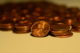 Small stacks of pennies, with one turned on its side to show the Abraham Lincoln portrait. (Photo by slgckgc via Flickr/Creative Commons https://flic.kr/p/azwPMu)