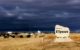 A welcome sign that reads "Welcome to Ulysses," with a dramatic cloudy sky in the background. (Photo by J. Stephen Conn via Flickr/Creative Commons https://flic.kr/p/5bfQeJ)