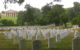 A field full of white military headstones at Arlington Cemetery. Arlington House is in the left background. (Photo by Torrey Wiley via Flickr/Creative Commons https://flic.kr/p/9YPeWQ)