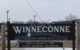 The welcome sign in Winneconne WI reads "Welcome to Winneconne - History's Crossing Place..." (Photo by Royalbroil - Own work, CC BY-SA 3.0, via Wikicommons https://commons.wikimedia.org/w/index.php?curid=9891375)