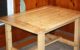 A large wooden kitchen table made from 2x4 pine boards.