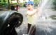 The two year old laughs and covers up as one of the hippo statues at Riverside Park sprays him with water.