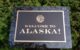 A sign says in gold letters "Welcome to Alaska!" (Photo by Philanthropy Northwest via Flickr/Creative Commons https://flic.kr/p/gv3e2C)