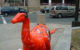 A statue of a red dinosaur with the names of Twin Cities musicians on its top and sides.