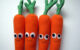 Four felt carrots with smiles and googly eyes. These are not the same as the large papier mache carrots made by Nathan the carrot man, but they're still fun. (Photo by Jackie Gallagher via Flickr/Creative Commons https://flic.kr/p/6ppWZG)