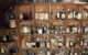 A liquor cellar with dozens of old bottles on wooden shelves. (Photo by mikepmiller via Flickr/Creative Commons https://flic.kr/p/7Rf1SA)